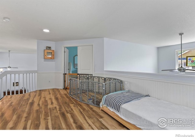 1169 Cooke Ct, Erie, CO 80516 - bedroom with a wainscoted wall and wood finished floors