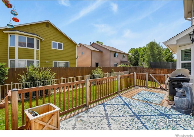 1169 Cooke Ct, Erie, CO 80516 - fenced backyard featuring a grill and a wooden deck
