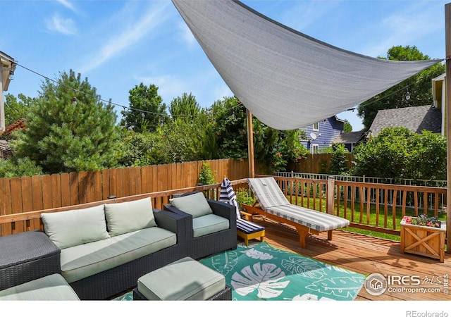 1169 Cooke Ct, Erie, CO 80516 - wooden deck featuring an outdoor living space and a fenced backyard