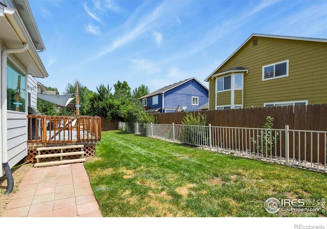 1169 Cooke Ct, Erie, CO 80516 - fenced backyard with a wooden deck