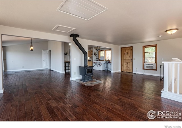 952 Steamboat Valley Rd, Lyons, CO 80540 - unfurnished living room featuring a wood stove, dark wood-style flooring, and healthy amount of natural light