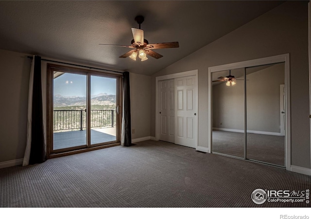 952 Steamboat Valley Rd, Lyons, CO 80540 - unfurnished bedroom with access to outside, two closets, carpet flooring, lofted ceiling, and ceiling fan