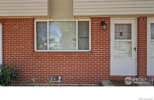 215 Chestnut St Unit A5, Windsor, CO 80550 - entrance to property with brick siding and crawl space