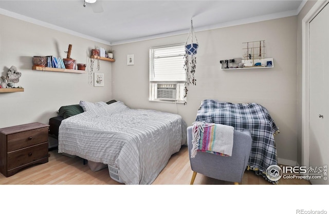 215 Chestnut St Unit A5, Windsor, CO 80550 - bedroom featuring wood finished floors, ornamental molding, and cooling unit