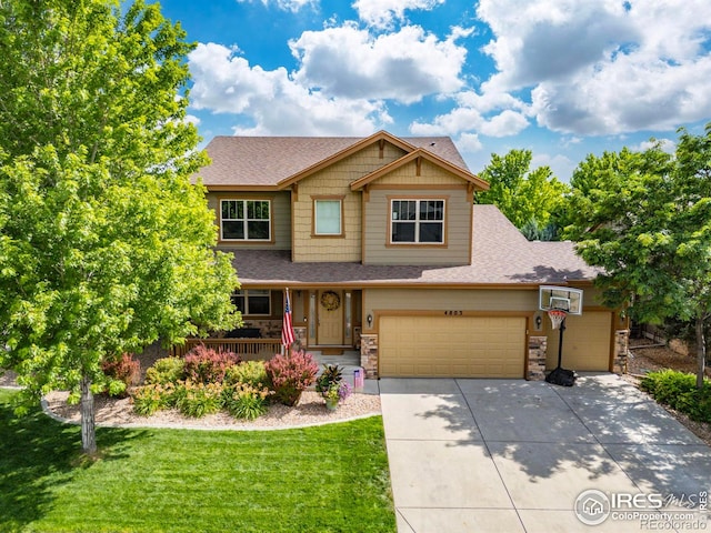 4803 Withers Dr, Fort Collins, CO 80524 - craftsman-style home featuring covered porch, concrete driveway, stone siding, and a front lawn