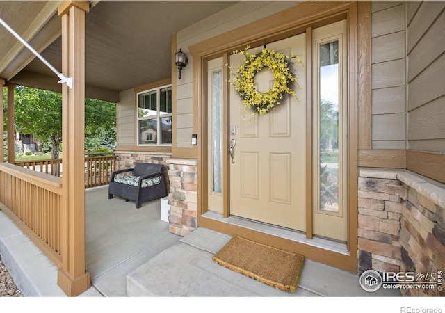 4803 Withers Dr, Fort Collins, CO 80524 - doorway to property featuring a porch and stone siding