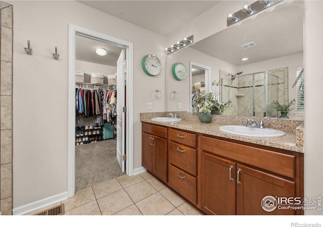 4803 Withers Dr, Fort Collins, CO 80524 - bathroom with a shower stall, tile patterned floors, double vanity, and a walk in closet