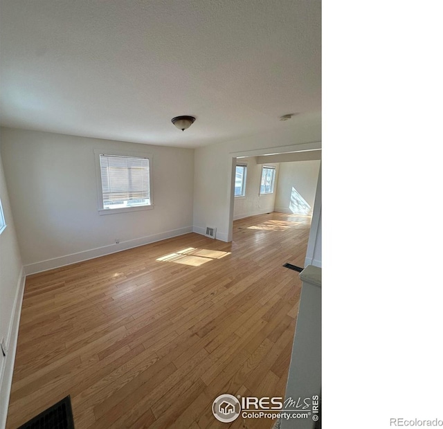 253 7th St, Frederick, CO 80530 - unfurnished room featuring healthy amount of natural light and light wood finished floors