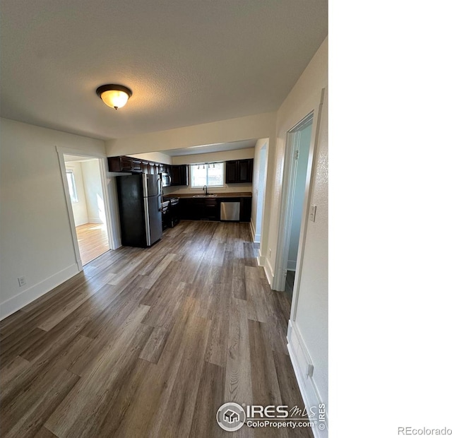 253 7th St, Frederick, CO 80530 - kitchen with freestanding refrigerator, dark wood-style flooring, dishwasher, and stove