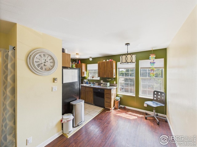 3200 Azalea Dr # 6, Fort Collins, CO 80526 - kitchen featuring brown cabinetry, light wood finished floors, black appliances, and pendant lighting