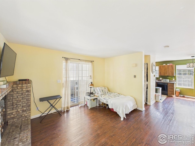 3200 Azalea Dr # 6, Fort Collins, CO 80526 - bedroom featuring access to exterior, wood finished floors, and a brick fireplace