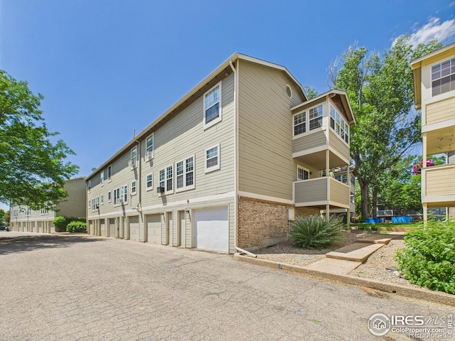 3200 Azalea Dr # 6, Fort Collins, CO 80526 - view of building exterior featuring a garage and driveway