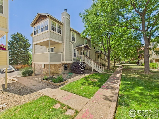 3200 Azalea Dr # 6, Fort Collins, CO 80526 - view of front of home featuring a chimney and a front yard