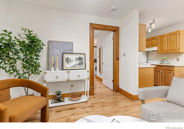 1430 18th St Unit 1, Boulder, CO 80302 - living area with stacked washer / drying machine and light wood-style floors