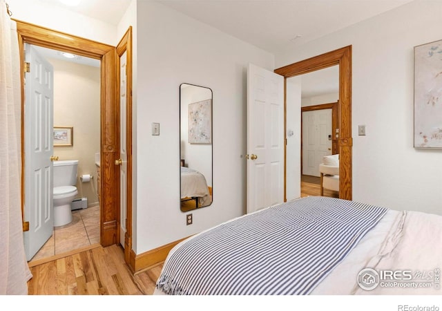 1430 18th St Unit 1, Boulder, CO 80302 - bedroom featuring light wood-style floors, ensuite bath, and a baseboard heating unit