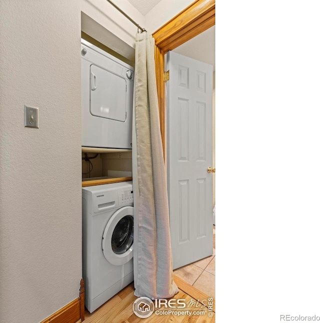 1430 18th St Unit 1, Boulder, CO 80302 - washroom featuring stacked washing machine and dryer, a textured wall, and light wood-style flooring