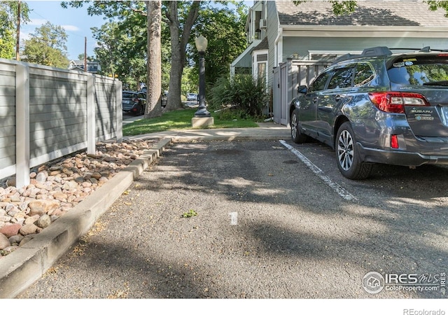 1430 18th St Unit 1, Boulder, CO 80302 - view of home's exterior with a shingled roof and uncovered parking