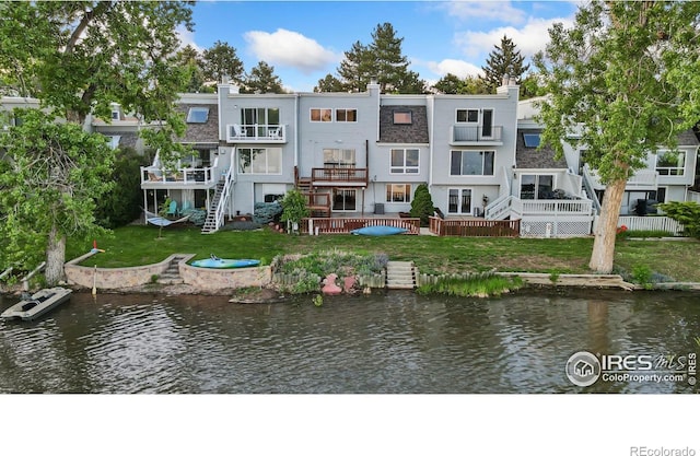 547 Spindrift Ct, Fort Collins, CO 80525 - rear view of house featuring a water view, a lawn, and a chimney