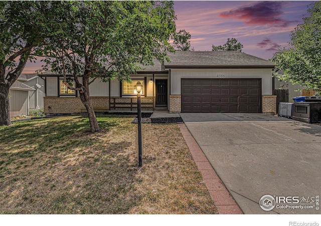 4386 Suncreek Dr, Loveland, CO 80538 - single story home with brick siding, an attached garage, and driveway