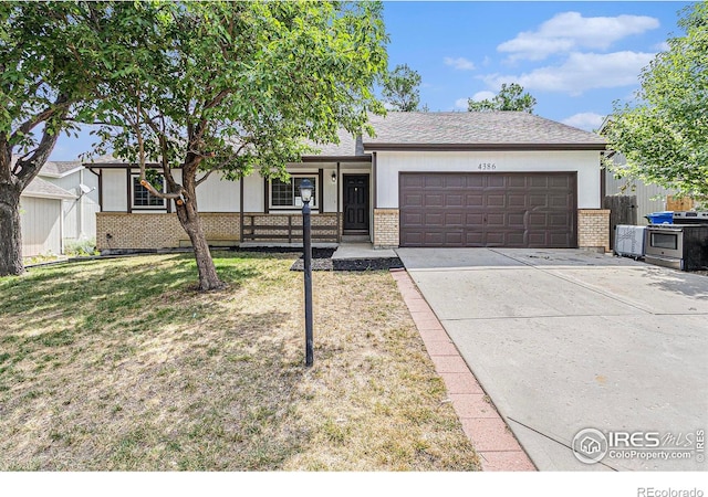 4386 Suncreek Dr, Loveland, CO 80538 - single story home featuring brick siding, a garage, driveway, and covered porch