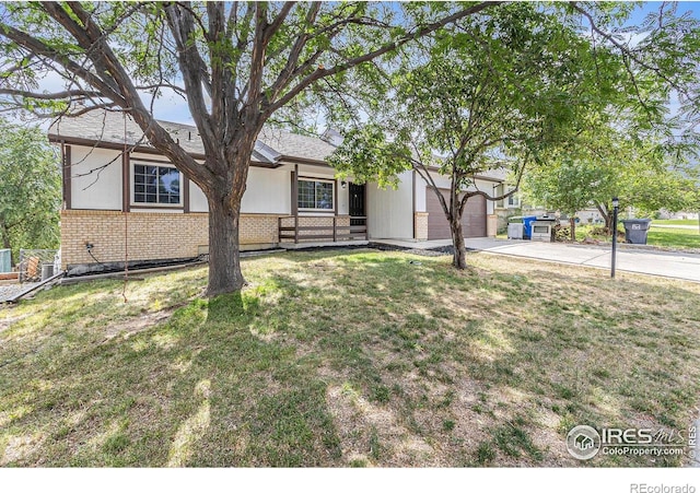 4386 Suncreek Dr, Loveland, CO 80538 - ranch-style home featuring brick siding, an attached garage, driveway, and a front yard