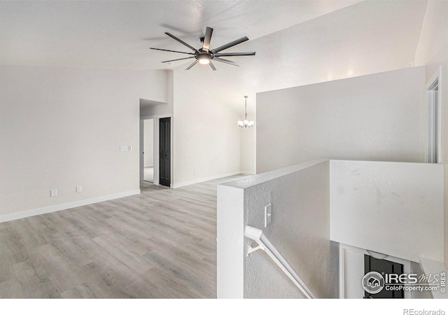 4386 Suncreek Dr, Loveland, CO 80538 - spare room featuring vaulted ceiling, wood finished floors, a chandelier, and ceiling fan