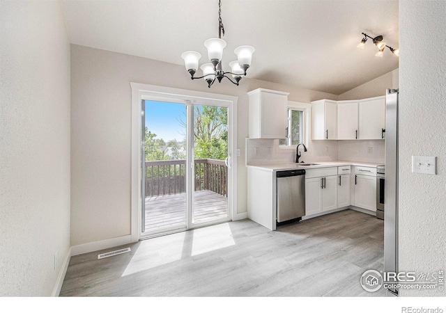 4386 Suncreek Dr, Loveland, CO 80538 - kitchen with tasteful backsplash, white cabinetry, a chandelier, light wood-type flooring, and lofted ceiling