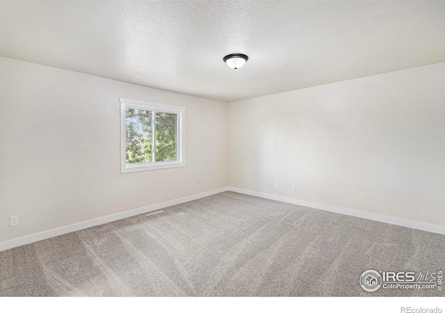 4386 Suncreek Dr, Loveland, CO 80538 - carpeted spare room with baseboards and a textured ceiling