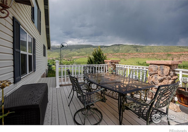 12711 Buckhorn Rd, Loveland, CO 80538 - deck with outdoor dining area and a mountain view