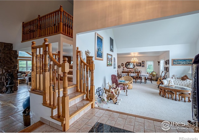 12711 Buckhorn Rd, Loveland, CO 80538 - stairs with high vaulted ceiling, a chandelier, and carpet flooring