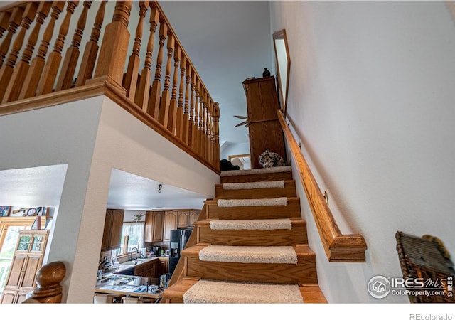 12711 Buckhorn Rd, Loveland, CO 80538 - stairs with a towering ceiling and wood finished floors