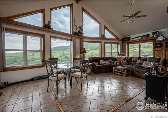 12711 Buckhorn Rd, Loveland, CO 80538 - living room with high vaulted ceiling, a ceiling fan, and stone tile floors
