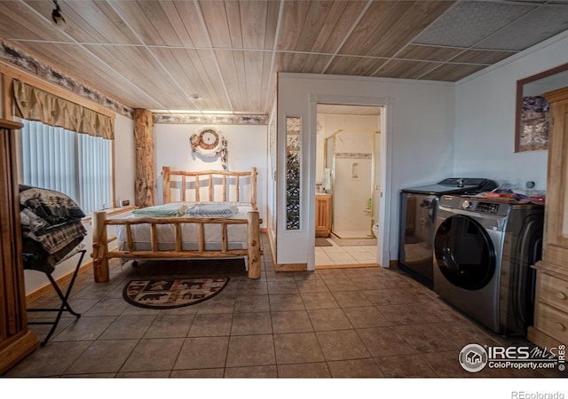 12711 Buckhorn Rd, Loveland, CO 80538 - bedroom featuring independent washer and dryer, dark tile patterned floors, wood ceiling, and ensuite bath