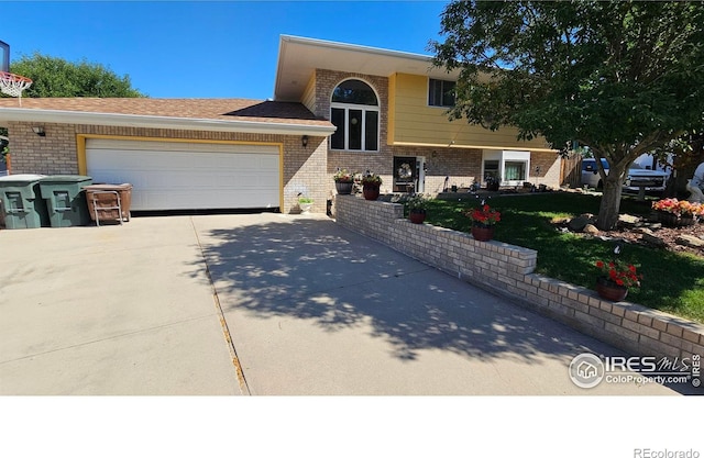 420 Applewood St, Brush, CO 80723 - raised ranch featuring brick siding, concrete driveway, an attached garage, and a front yard