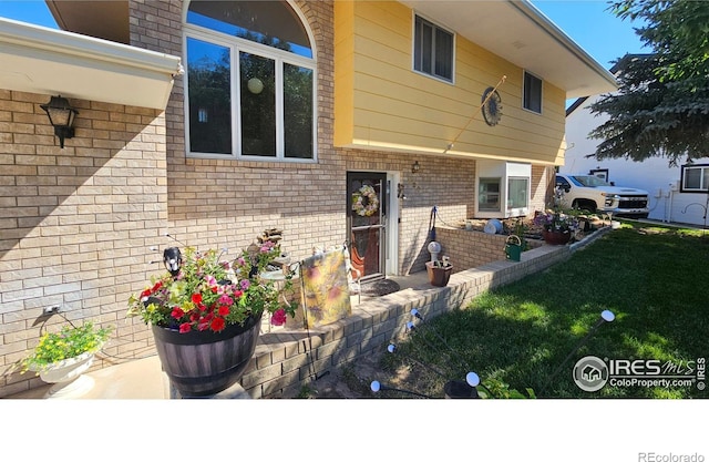 420 Applewood St, Brush, CO 80723 - entrance to property featuring brick siding and a yard