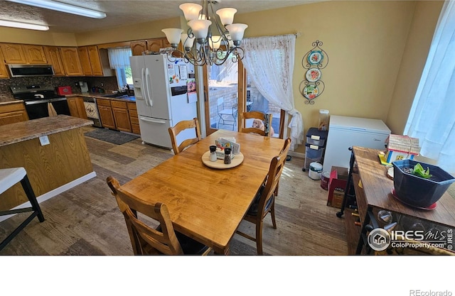 420 Applewood St, Brush, CO 80723 - dining area with dark wood-type flooring and a chandelier