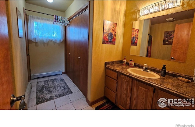 420 Applewood St, Brush, CO 80723 - bathroom featuring vanity, a baseboard radiator, tile patterned flooring, and a textured wall