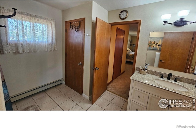 420 Applewood St, Brush, CO 80723 - bathroom with baseboard heating, vanity, and tile patterned floors