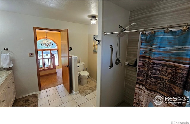 420 Applewood St, Brush, CO 80723 - full bathroom featuring a chandelier, vanity, tile patterned floors, and curtained shower