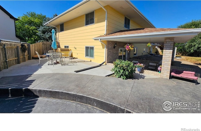 420 Applewood St, Brush, CO 80723 - rear view of property featuring a patio, brick siding, and outdoor dining space