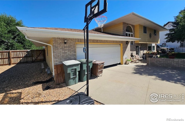 420 Applewood St, Brush, CO 80723 - view of side of property with brick siding, driveway, and an attached garage