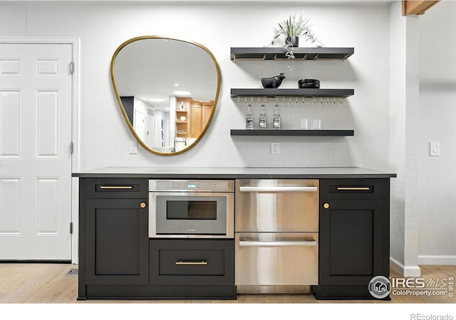 2545 Woodstock Pl, Boulder, CO 80305 - indoor dry bar with light wood-style flooring and stainless steel dishwasher
