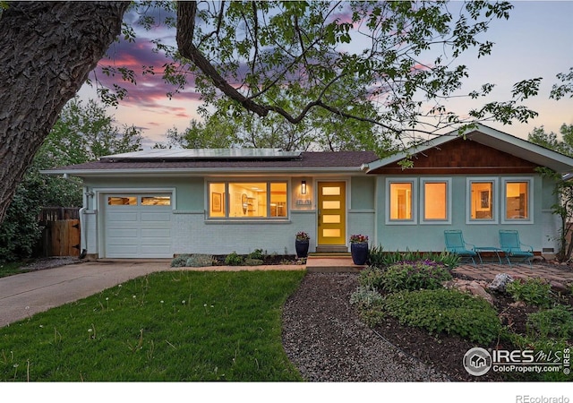 2545 Woodstock Pl, Boulder, CO 80305 - ranch-style home with an attached garage, roof mounted solar panels, and concrete driveway