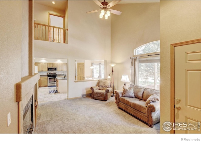 4500 Seneca St Unit 11, Fort Collins, CO 80526 - living room featuring a high ceiling, light colored carpet, a ceiling fan, and a fireplace