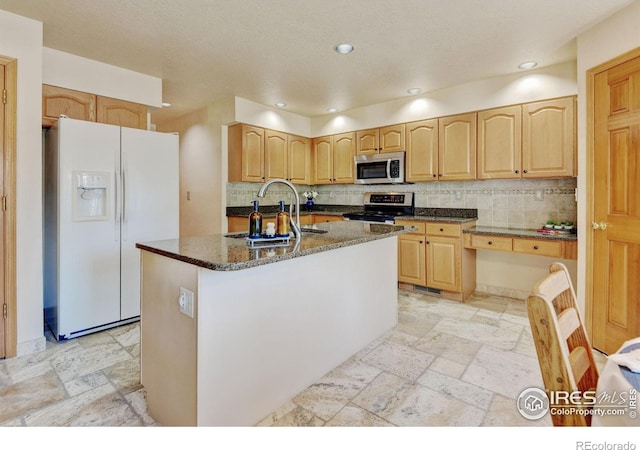 4500 Seneca St Unit 11, Fort Collins, CO 80526 - kitchen with appliances with stainless steel finishes, stone tile flooring, light brown cabinetry, and recessed lighting