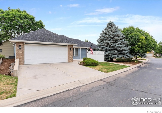 3822 W 11th St Unit 35, Greeley, CO 80634 - single story home with an attached garage, driveway, brick siding, and roof with shingles