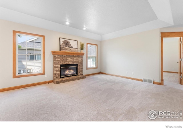3822 W 11th St Unit 35, Greeley, CO 80634 - unfurnished living room with plenty of natural light, carpet floors, and a brick fireplace