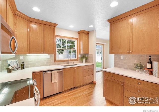 3822 W 11th St Unit 35, Greeley, CO 80634 - kitchen featuring appliances with stainless steel finishes, light wood-style floors, tasteful backsplash, light countertops, and recessed lighting