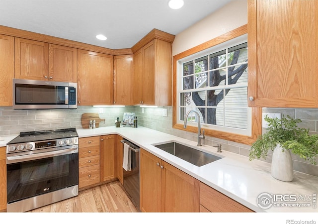 3822 W 11th St Unit 35, Greeley, CO 80634 - kitchen featuring appliances with stainless steel finishes, light countertops, light wood-type flooring, backsplash, and recessed lighting