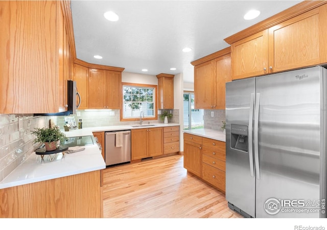 3822 W 11th St Unit 35, Greeley, CO 80634 - kitchen with stainless steel appliances, light wood-style floors, tasteful backsplash, recessed lighting, and light countertops
